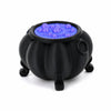 Black cauldron ornament with a glowing blue liquid inside