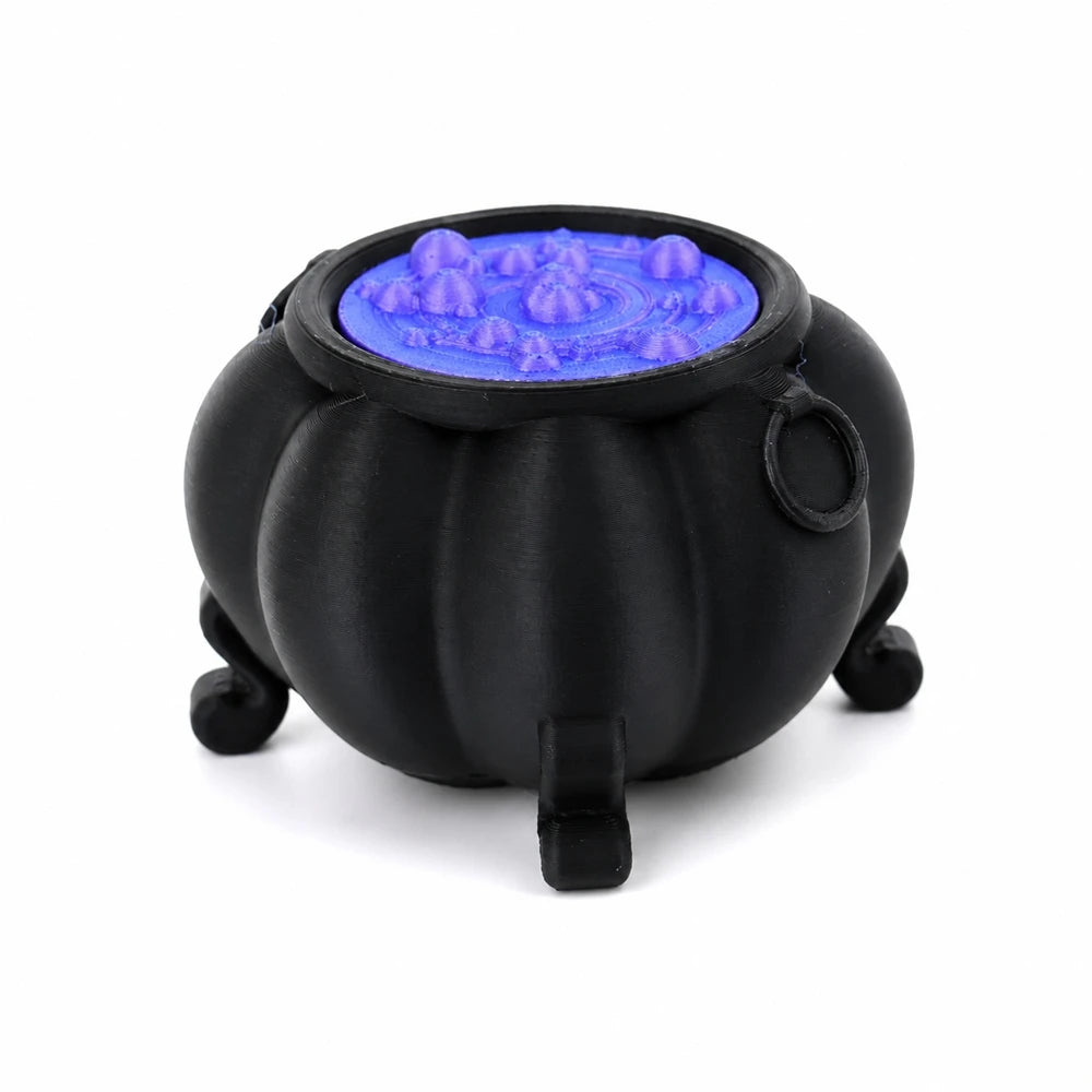 Black cauldron ornament with a glowing blue liquid inside
