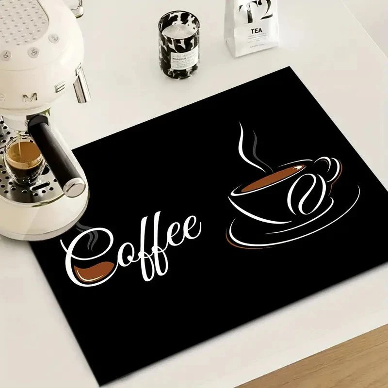 A black print featuring a stylized cup of coffee on a mat, next to a white coffee maker and tea packaging.