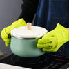 A pair of bright lime green silicone heat resistant kitchen and BBQ gloves resting on a cooking surface.