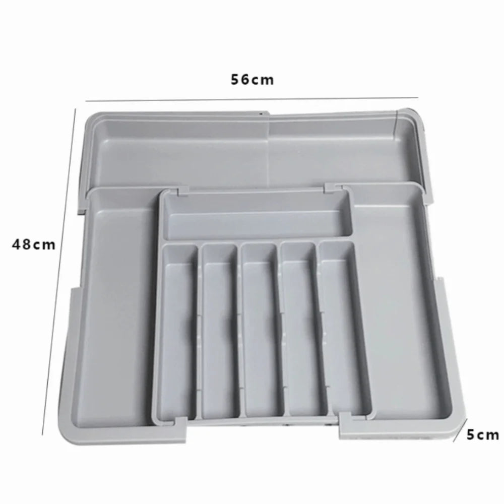 A rectangular gray organizer tray with multiple compartments for cutlery and utensils.