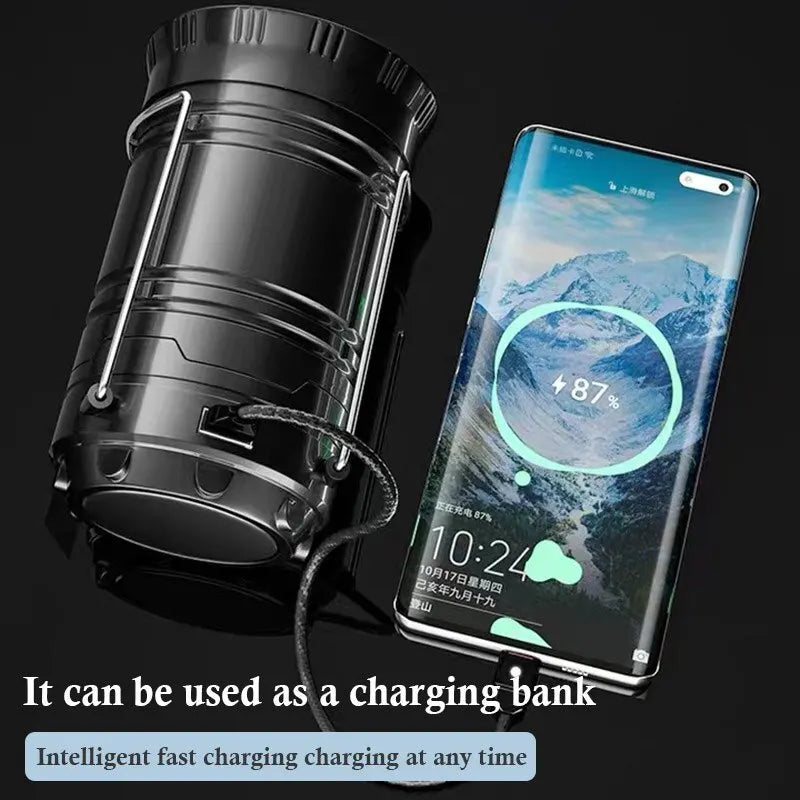 A portable solar LED flashlight and camping lantern next to a smartphone, demonstrating its use as a charging bank.