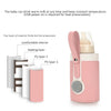 A pink baby bottle warmer device with a silicone nipple and a clear bottle component, showing its layered structure.