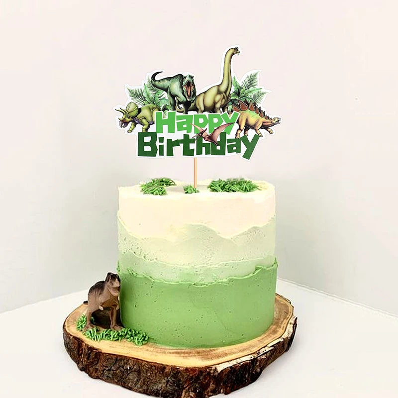 A green frosted cake with dinosaur themed toppers on a wooden slab.