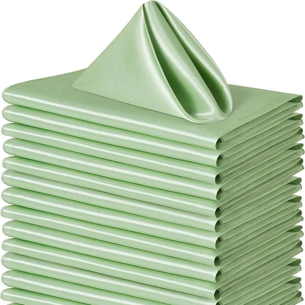 A stack of ten light green satin dinner napkins folded neatly.