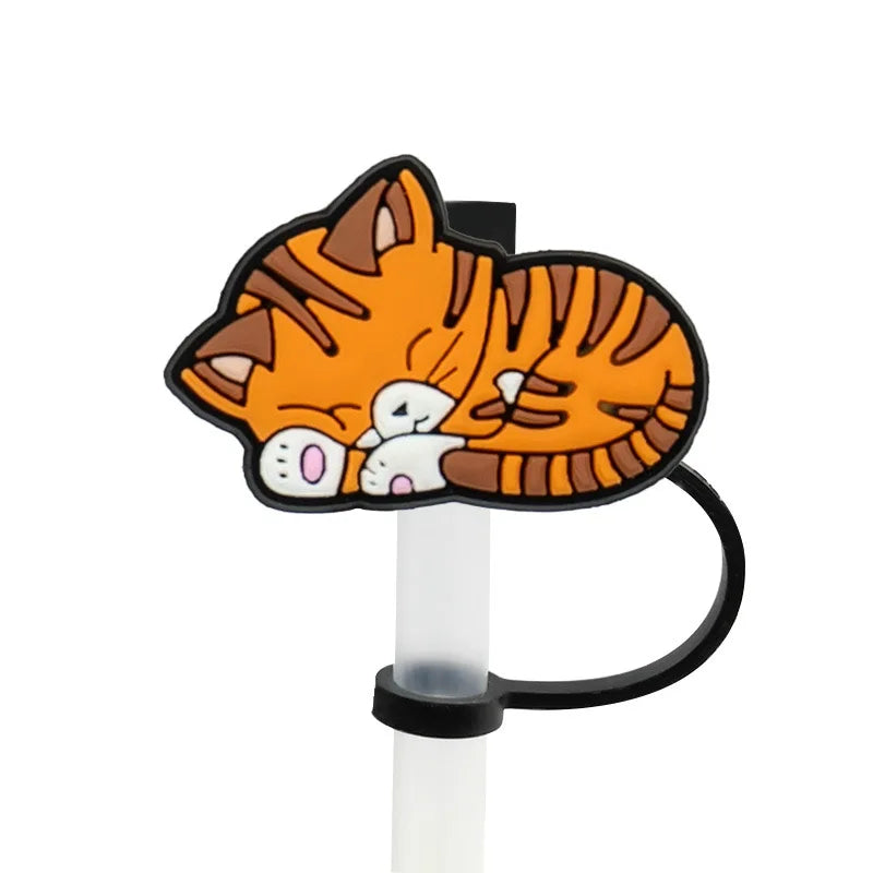 An orange and black striped cat silicone straw cover attached to a clear plastic straw.