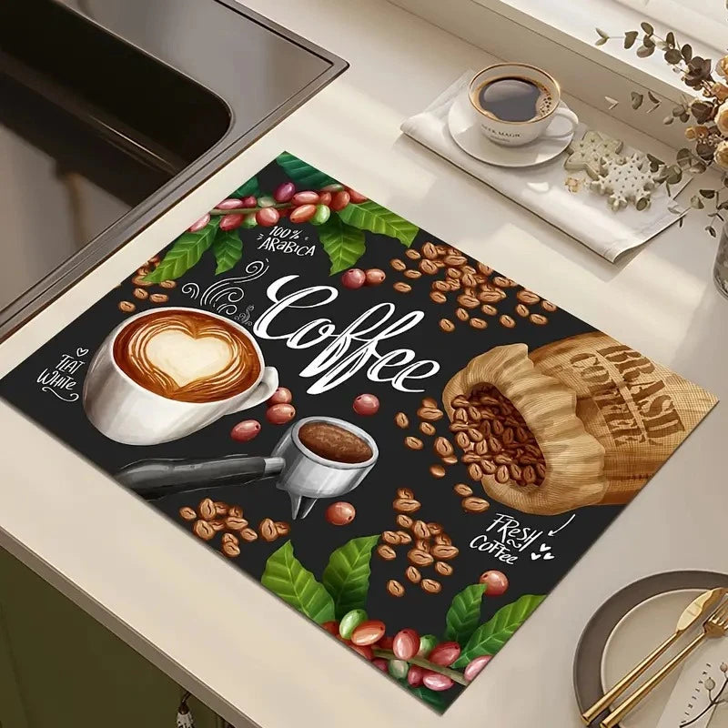 A dark green print featuring coffee beans, leaves, and a cup of latte art on a kitchen drying mat.