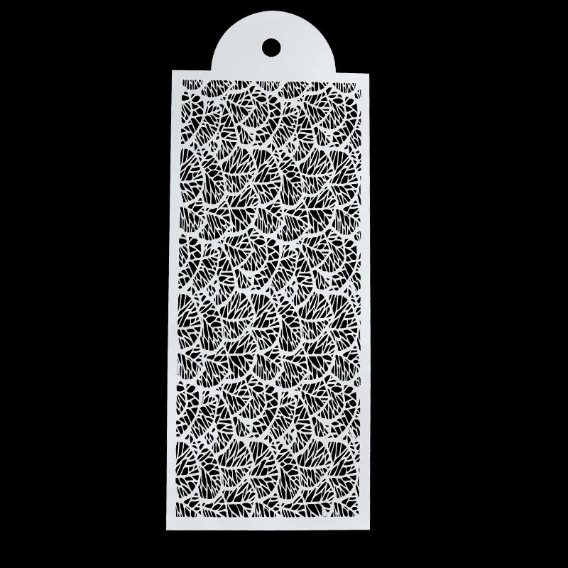 A white laser-cut stencil featuring a detailed floral pattern on a rectangular piece of material.