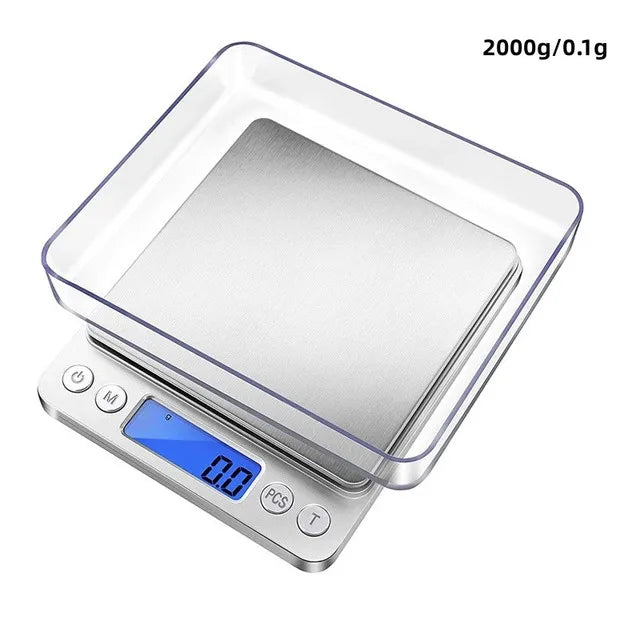 A clear plastic container holding a silver digital kitchen scale with a blue display showing 0.0