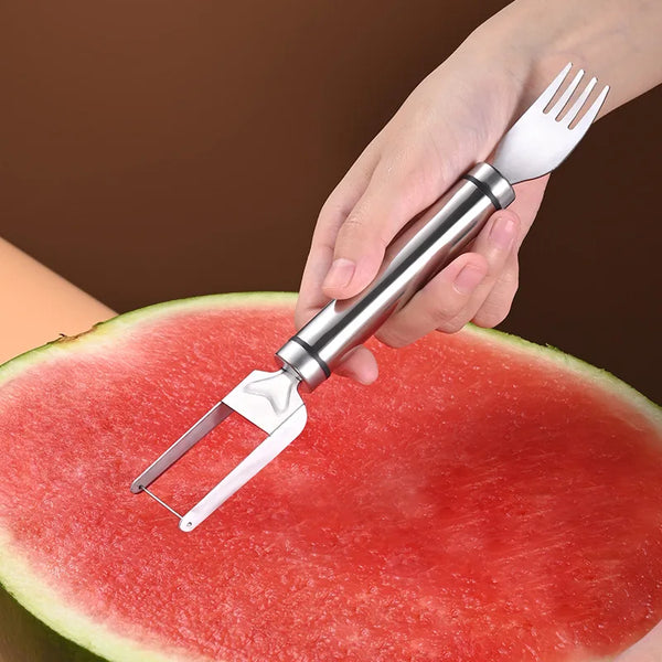 A hand holds a stainless steel watermelon cutting and slicing tool, demonstrating its use on a slice of watermelon.