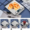 A precision digital kitchen scale is shown measuring a piece of baked bread on a dark blue surface.