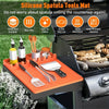 Orange silicone spatula tools mat with silicone utensils inside a grill
