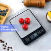 A digital kitchen scale with a stainless steel platform displaying three red tomatoes on a light gray surface.