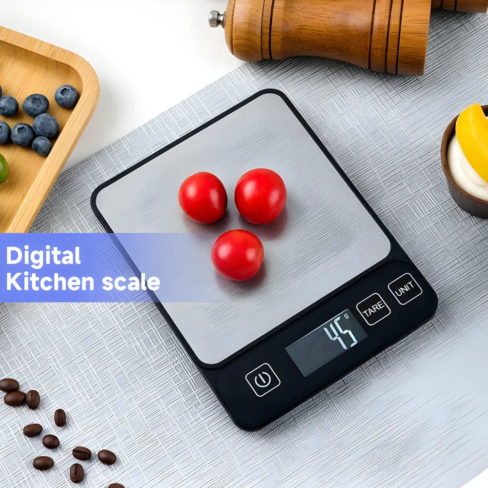 A digital kitchen scale with a stainless steel platform displaying three red tomatoes on a light gray surface.