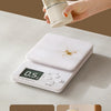 A hand is pressing a white digital scale, demonstrating one press for a quantitative amount of salt discharge.