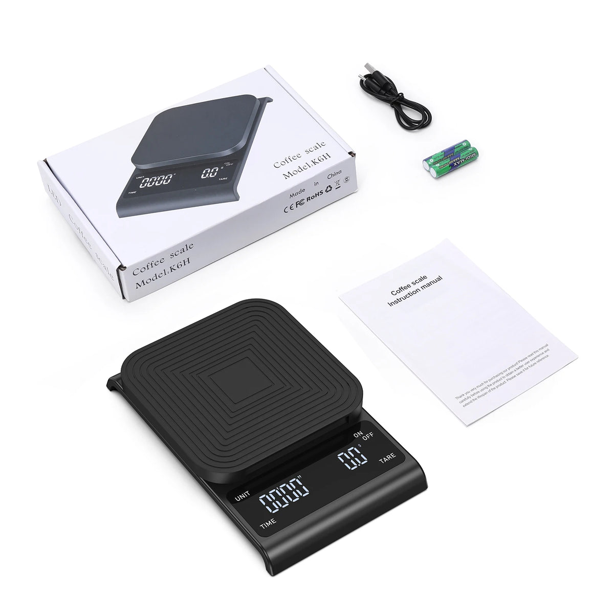 A black digital coffee scale with a timer is shown next to its packaging and instruction manual.