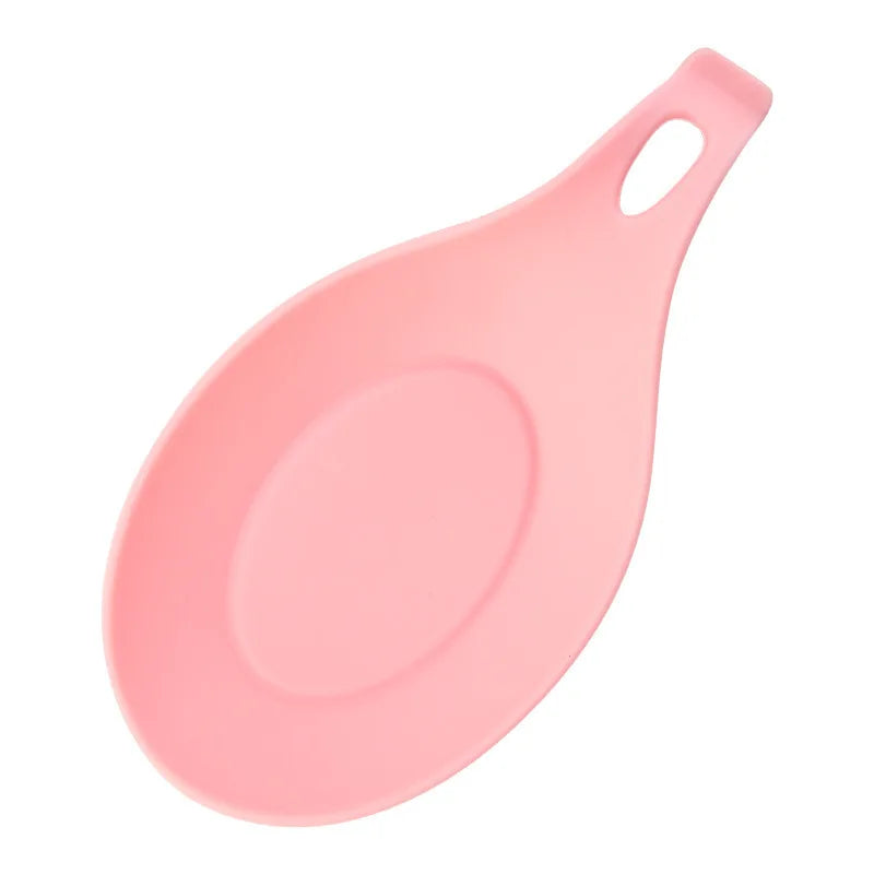 A pink silicone kitchen utensil holder and organizer rack with a spoon-shaped design.