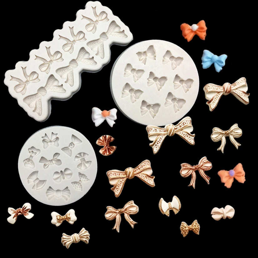 A collection of silicone baking molds in various shapes and colors including bows and flowers.