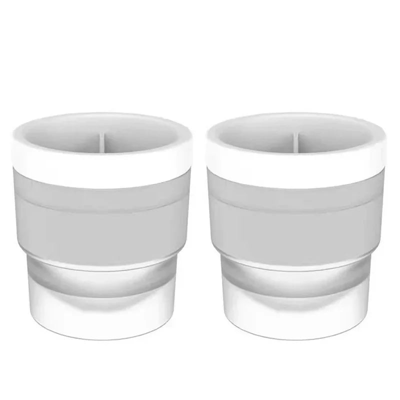 A pair of stackable food-grade ice molds for cocktails, shown in white.