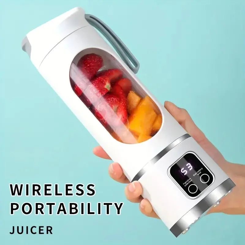 A hand holds a white portable handheld juicer blender filled with fresh strawberries and orange segments.