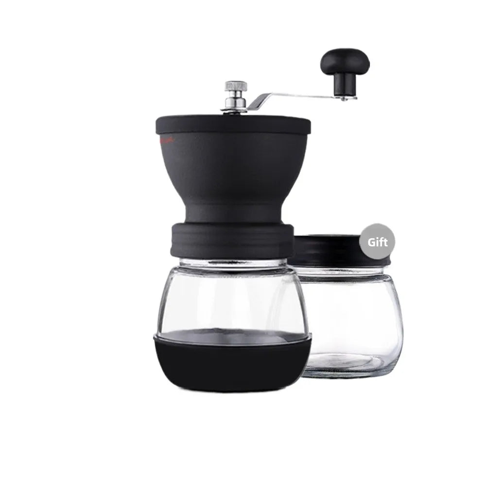 A black manual coffee grinder with a glass burr and a sealed storage container.