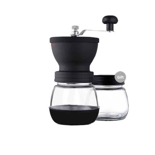 A black manual coffee grinder with a glass burr and a sealed storage container.