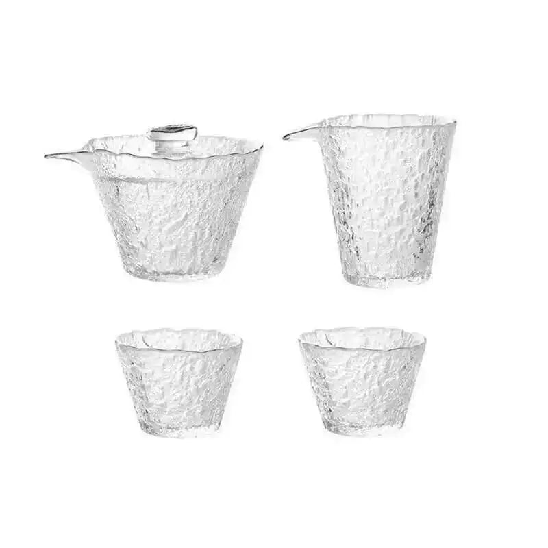 A set of three clear glass tea cups and a teapot for Chinese and Japanese ceremony.