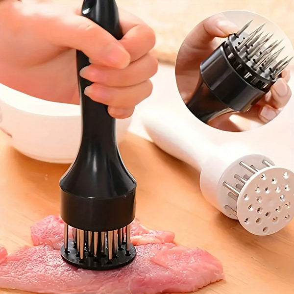 Eine Hand hält ein schwarzes Fleisch-Entzerrerwerkzeug mit Metallzinken über rohes Fleisch.