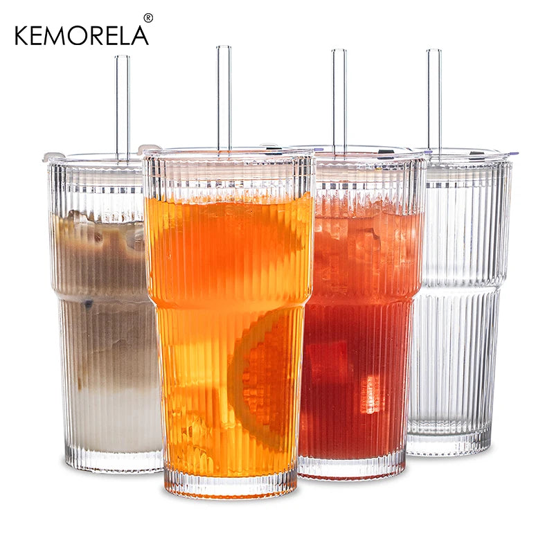 Three glass coffee cups filled with orange and red beverages featuring vertical stripes.