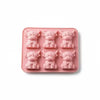 A silicone mold tray containing six pink, elephant-shaped ice cube molds.