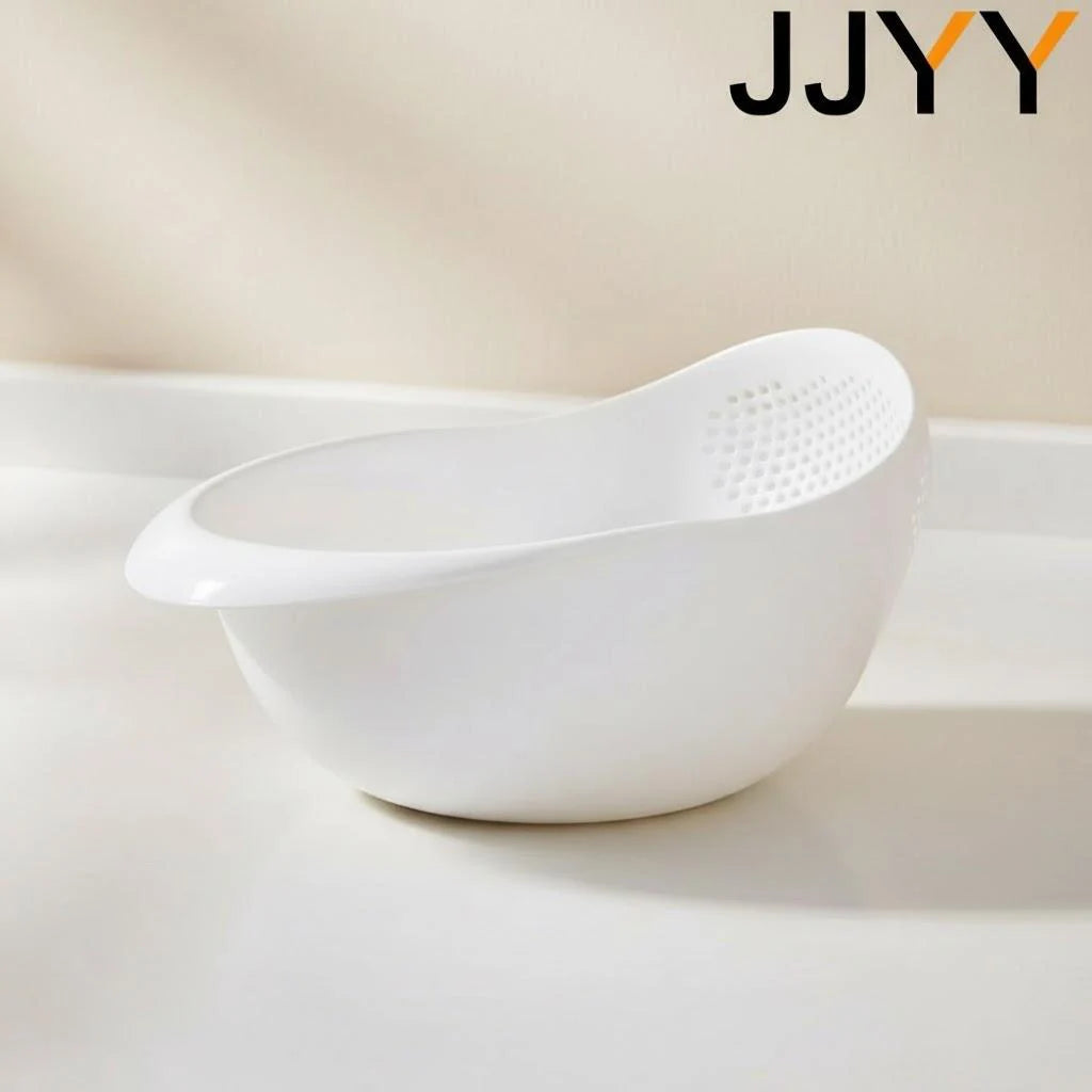 A white multi-use kitchen drainer colander set sitting on a light surface.