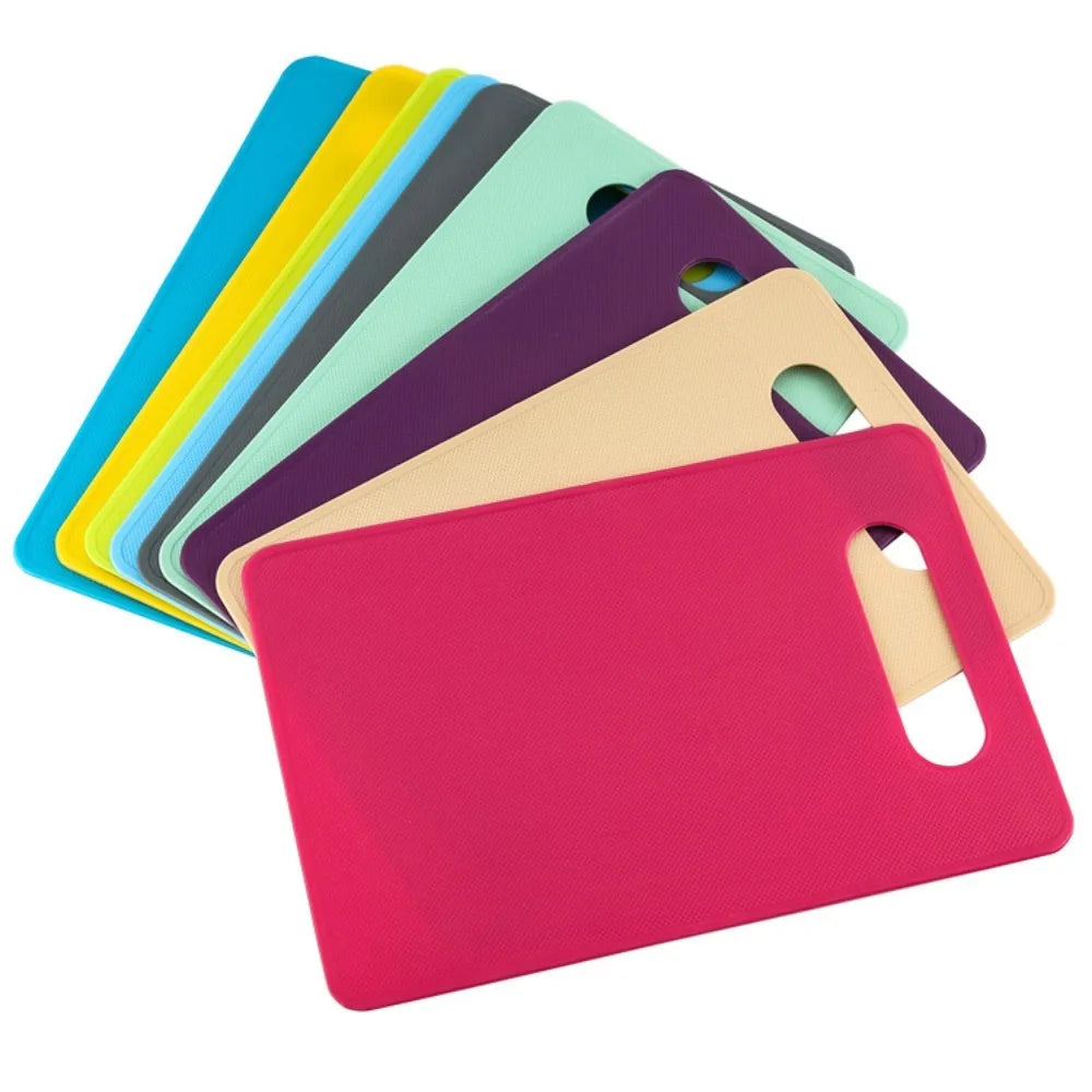 A set of colorful plastic cutting boards stacked diagonally, showing various shades including yellow, green, purple, and pink