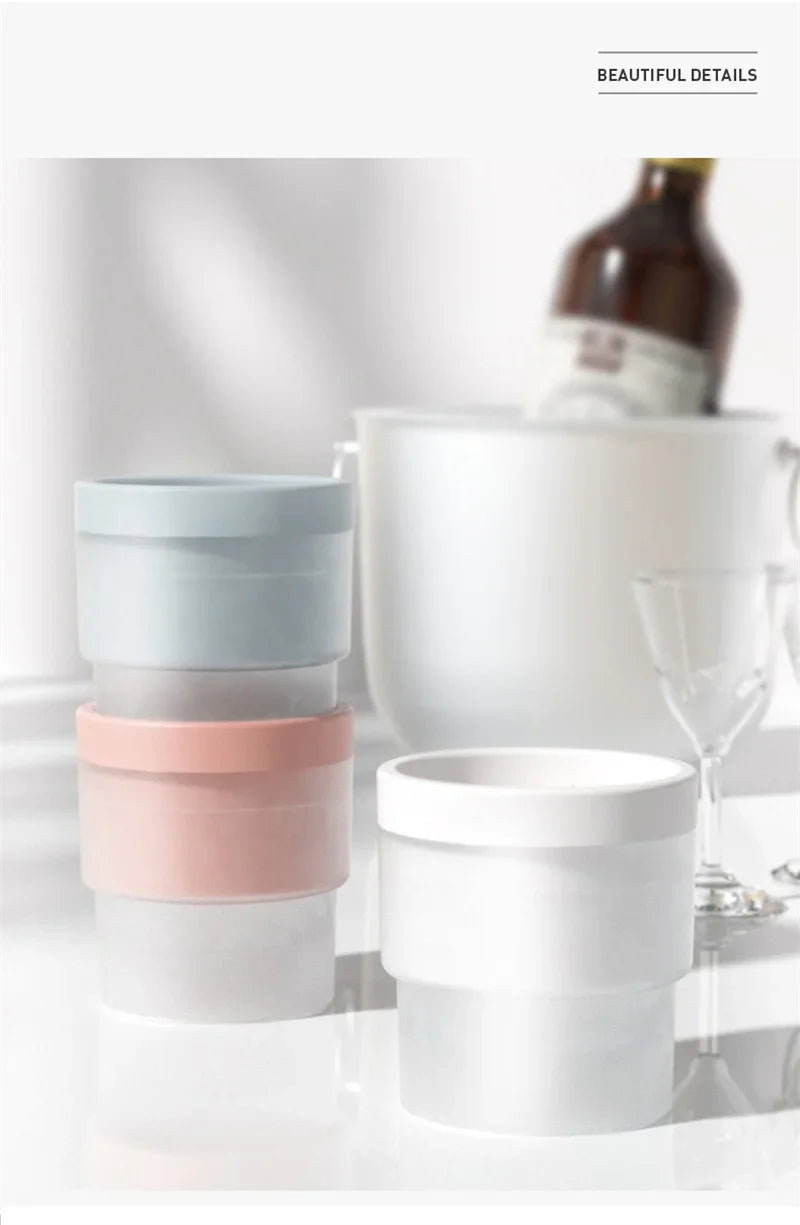 A stack of four food-grade ice molds in pastel colors, including light blue, mint green, pale gray, and blush pink.