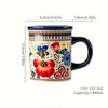 A ceramic mug featuring a colorful bohemian floral design with blue, red, and yellow flowers.