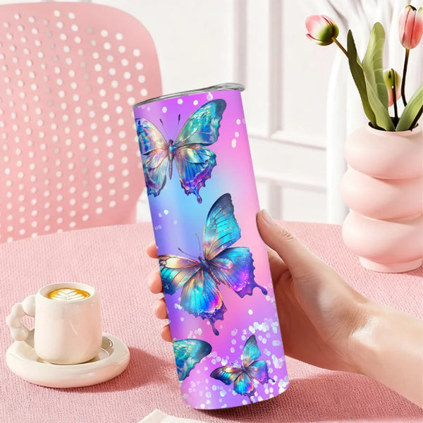 Eine Hand hält eine isolierte Edelstahl-Wasserflasche mit Strohhalm, thematisiert durch ein lila und blaues Schmetterlingmoti