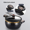 Close-up view of a black non-stick pressure cooker lid demonstrating the slide lock mechanism for unlocking.