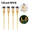 Twelve LED 4-piece solar flame effect garden path lights with wooden stakes.