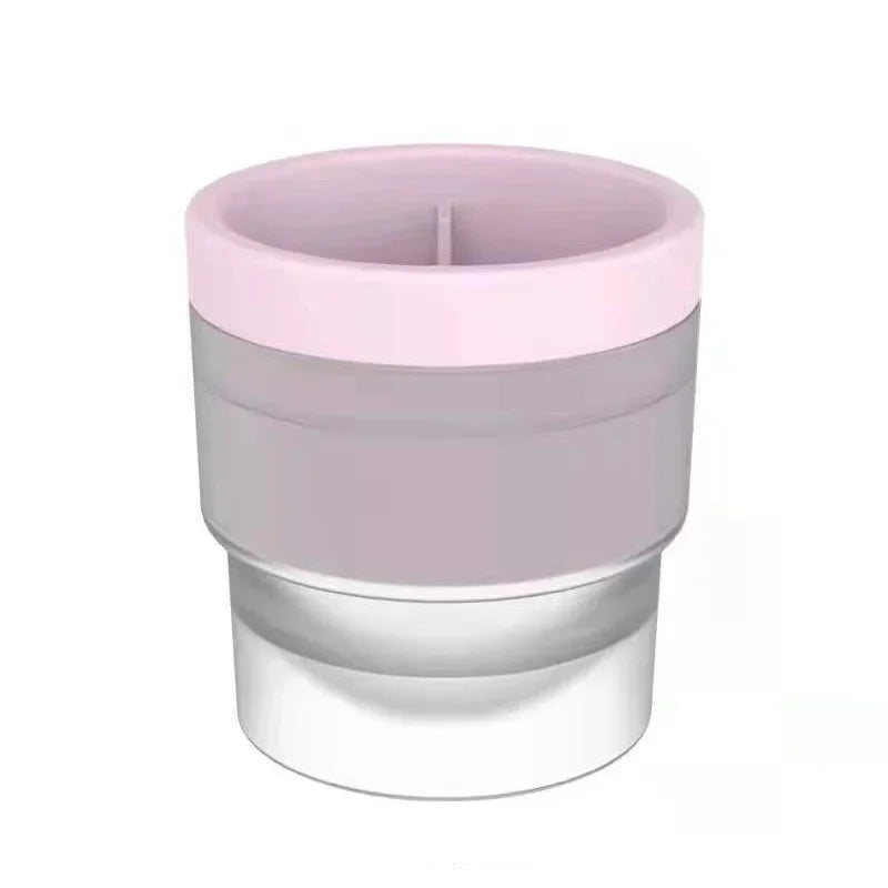 A stackable food-grade ice mold with a pink top and clear base.