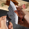 A hand is holding a handmade forged butcher and chef knife set, demonstrating the blade and handle.