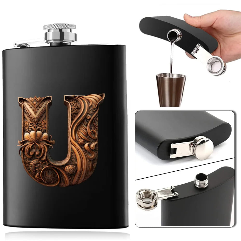 A black stainless steel flask water bottle featuring an ornate gold U design and a separate metal pourer.