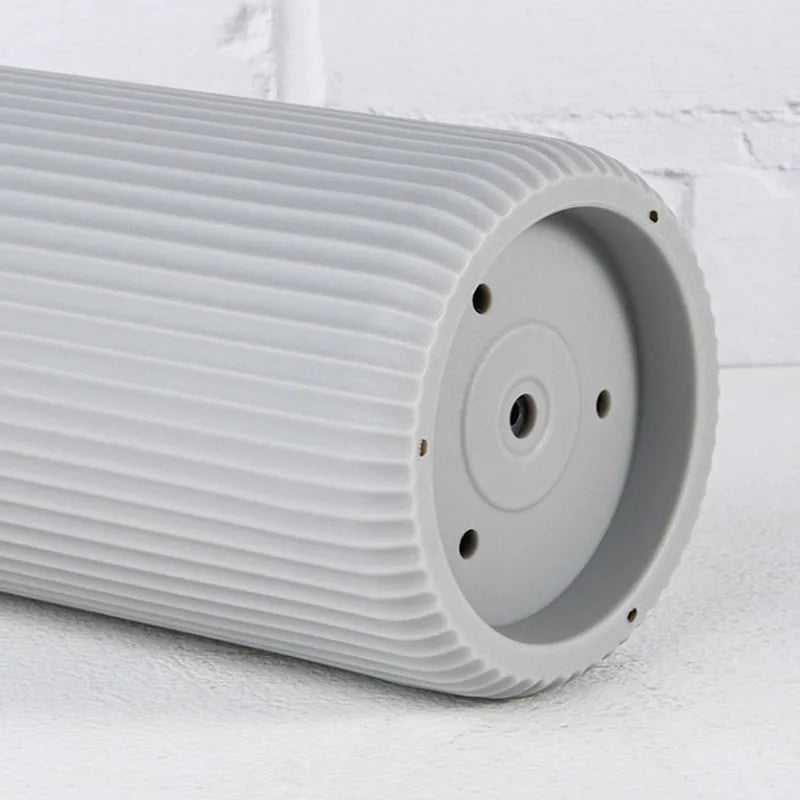 A cylindrical, ribbed white knife block organizer with a circular opening and mounting holes.