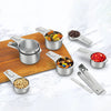 A stainless steel measuring cup and spoon set with various sized scoops and spoons arranged on a wooden board.