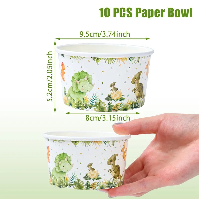 A hand holds a white paper bowl featuring a dinosaur pattern, with dimensions marked.