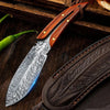 A premium boning chef's knife with a wooden handle and leather holster resting on a dark wooden surface.