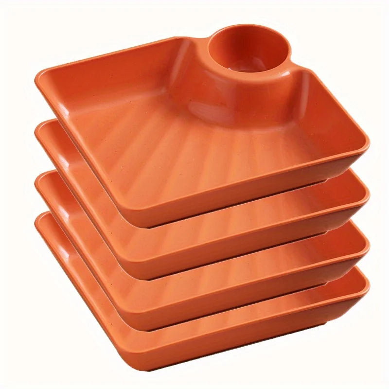A stack of three orange serving plates for appetizers and charcuterie.
