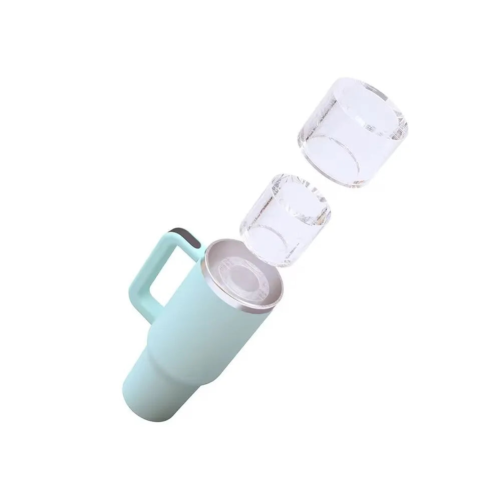 A light blue silicone ice cube tray with two ice cubes visible, designed for tumblers.