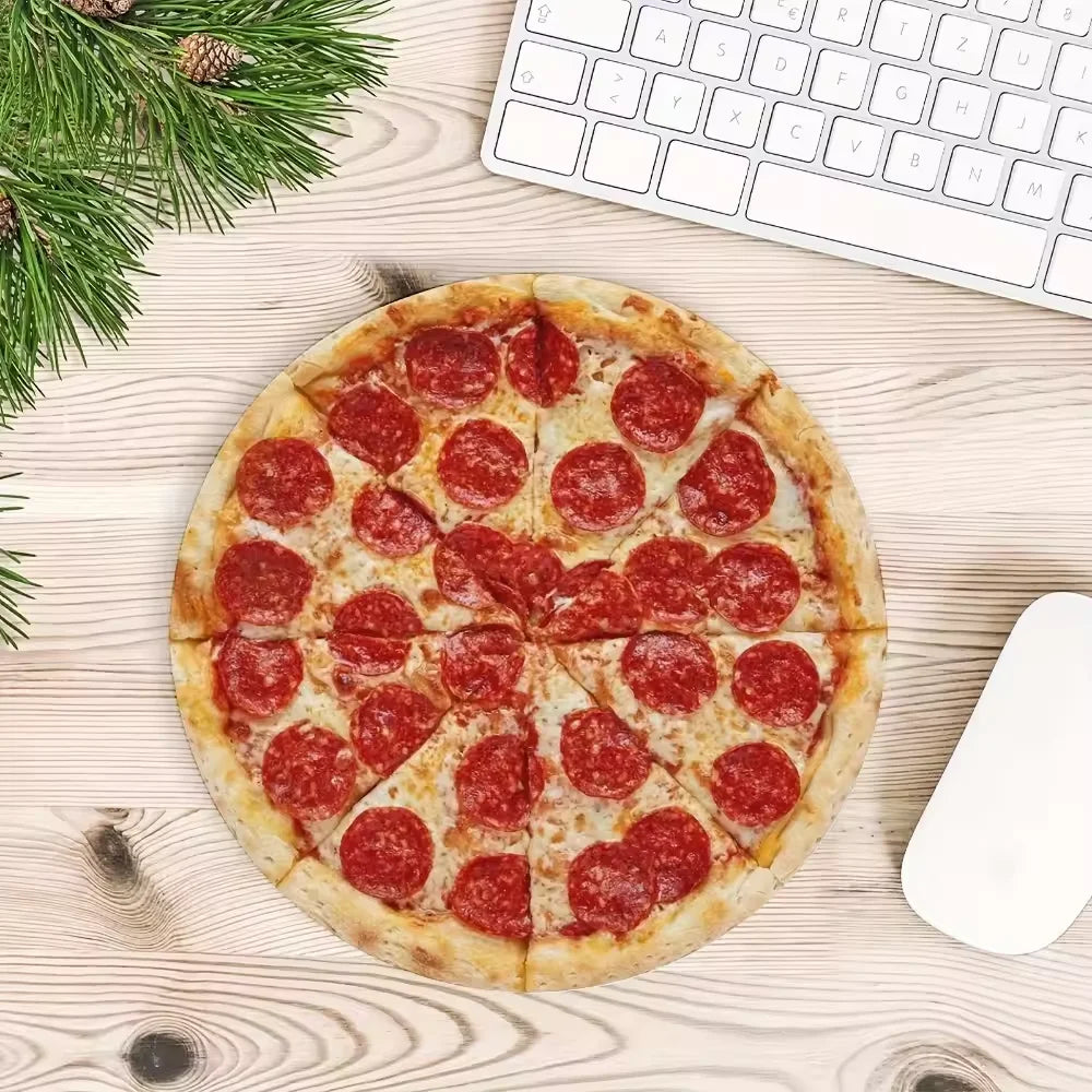 A round pizza is placed on a light wooden surface next to a white computer mouse and a white keyboard.