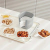 A white plastic sauce dish set for seasoning and serving featuring a main container and several small serving dishes of nuts