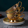A gold-toned luxury bone china tea set featuring ceramic cups and saucers with intricate floral designs.