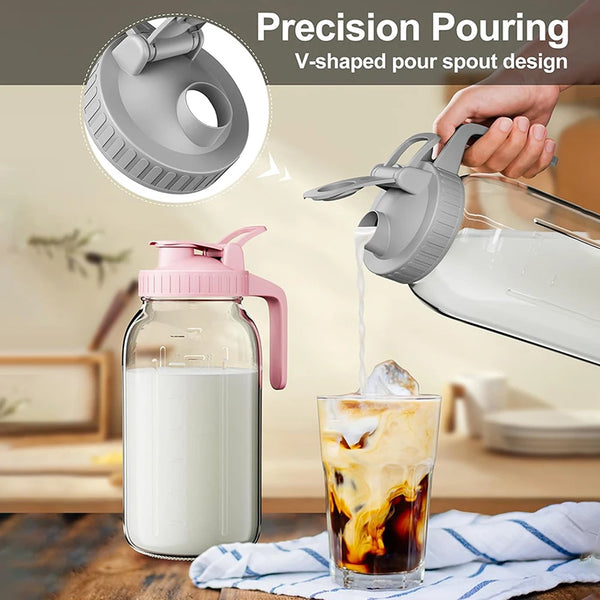 A hand pours a liquid from a V-shaped pour spout glass pitcher into an iced beverage.